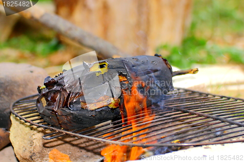 Image of eggplant roasting in flames