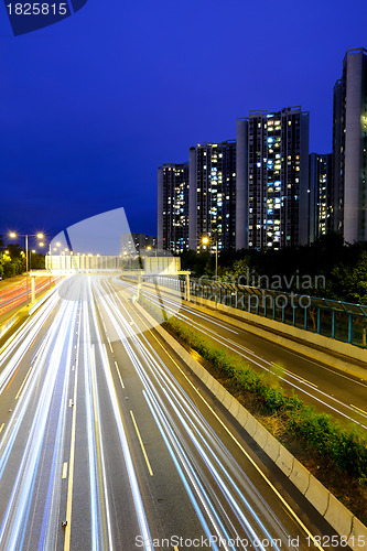 Image of traffic with blur light through city at night