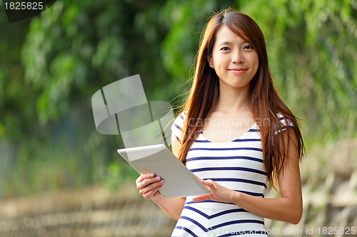 Image of young woman using tablet touch computer