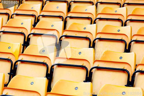 Image of yellow plastic seats at stadium