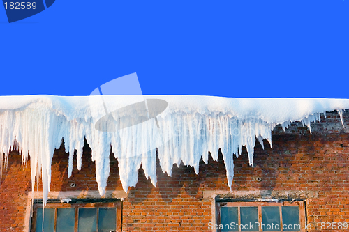 Image of Snow cover on roof of old textile fabric with icicles