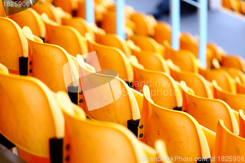 Image of yellow plastic seats at stadium