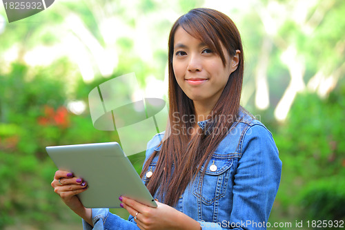 Image of young woman using tablet touch computer