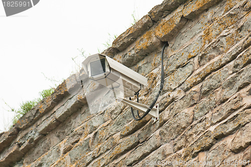 Image of Video camera of system of supervision on a building wall 