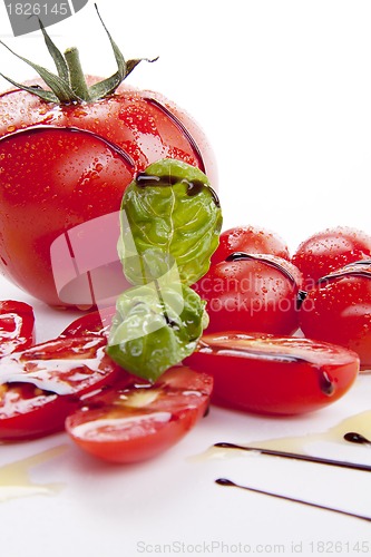Image of fresh red tomatoes with balsamic and oilve oil isolated