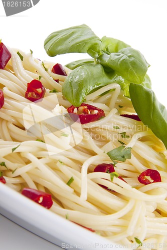 Image of fresh pasta with chilli and basil isolated