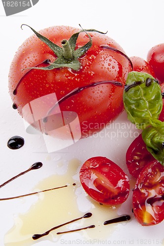 Image of fresh red tomatoes with balsamic and oilve oil isolated