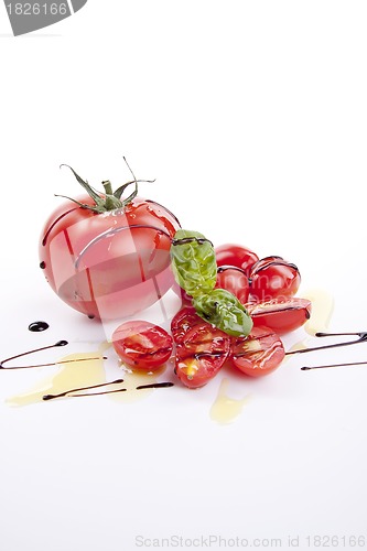 Image of fresh red tomatoes with balsamic and oilve oil isolated