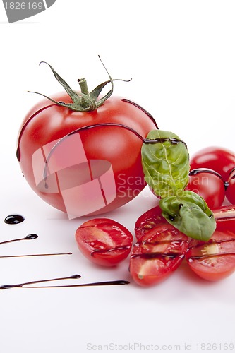 Image of fresh red tomatoes with balsamic and oilve oil isolated