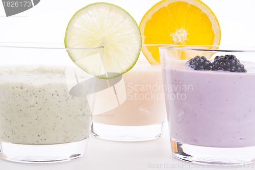 Image of fresh tasty lime and orange yoghurt shake cream isolated