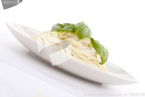 Image of fresh delicious pasta with basil isolated on white