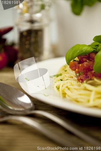 Image of delicious fresh spaghetti with tomato sauce and parmesan on table