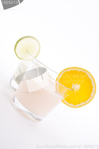 Image of fresh tasty lime and orange yoghurt shake cream isolated