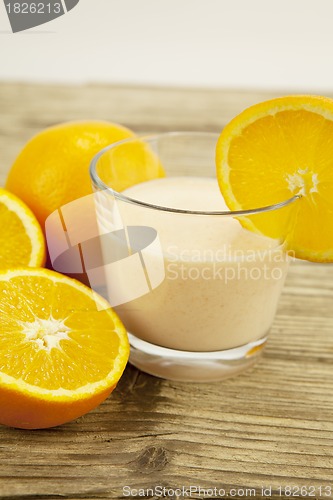 Image of fresh tropical orange yoghurt shake dessert on table