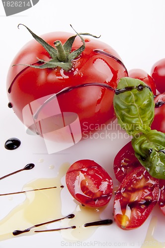 Image of fresh red tomatoes with balsamic and oilve oil isolated