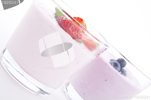 Image of fresh tasty strawberry blueberry yoghurt shake cream isolated