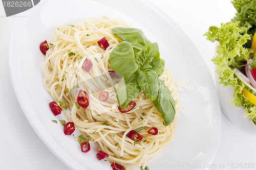 Image of fresh pasta with chilli and basil isolated