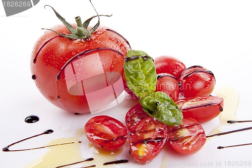 Image of fresh red tomatoes with balsamic and oilve oil isolated