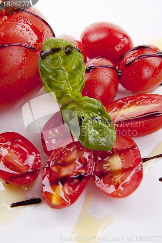 Image of fresh red tomatoes with balsamic and oilve oil isolated