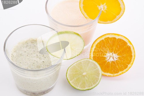 Image of fresh tasty lime and orange yoghurt shake cream isolated