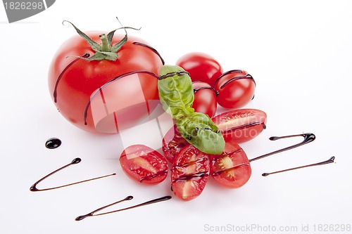 Image of fresh red tomatoes with balsamic and oilve oil isolated