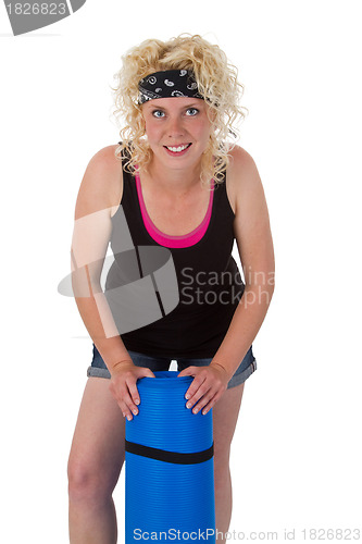 Image of Young woman with yoga mat