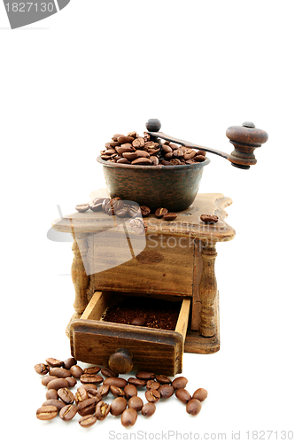 Image of Old wooden mill with coffee beans.