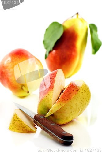 Image of Three ripe pears and knife.