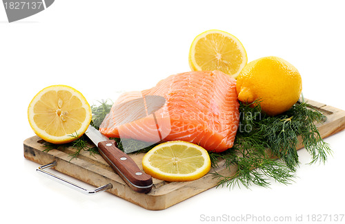 Image of Fresh salmon with herbs and lemon.