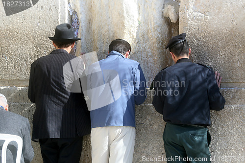 Image of Jewish men pray at the western wall