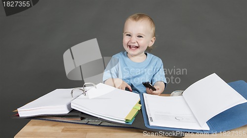 Image of child with paperwork at desk