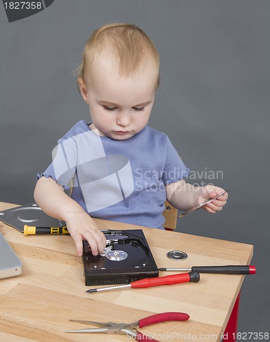 Image of child working at open hard drive