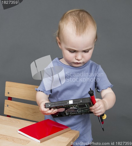 Image of child with hard drive and tools