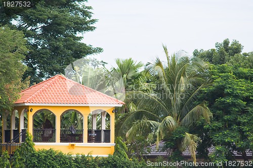 Image of Yellow pavilion in tropical surroundings