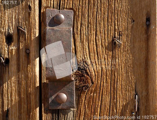 Image of Antique iron handle on weathered door