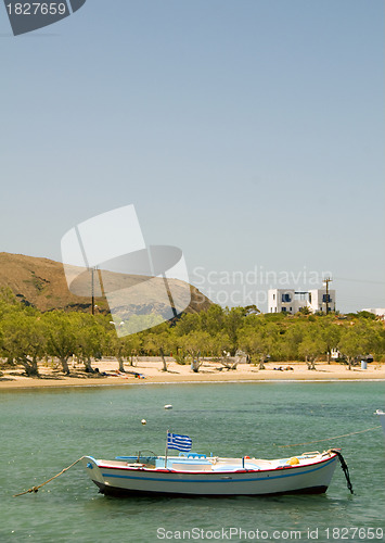 Image of Greek fishing boat sandy beach with cypress trees Pollonia Milos