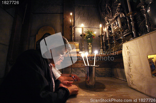 Image of Pilgrims pray at the tomb of Jesus in the Church of the Holy Sepulchre, Jerusalem