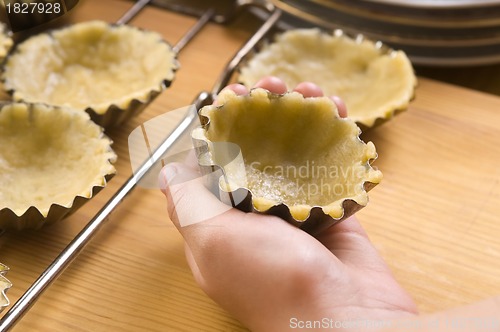 Image of Detail of child hands making cookies