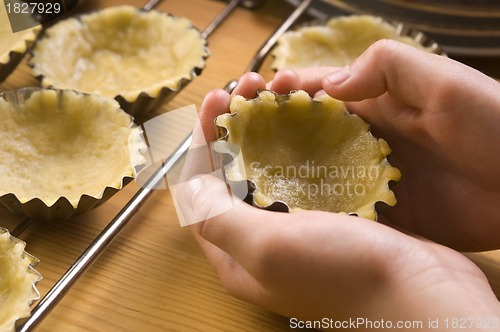 Image of Detail of child hands making cookies