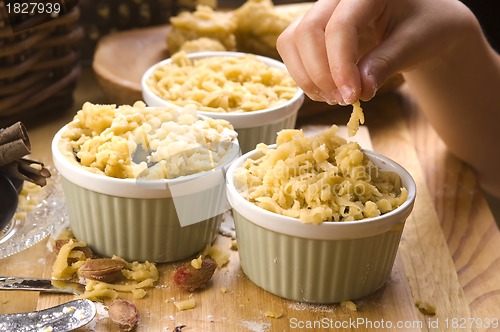 Image of Detail of child hands making plum tart