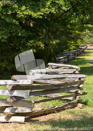 Image of Split rail fence by edge of forest