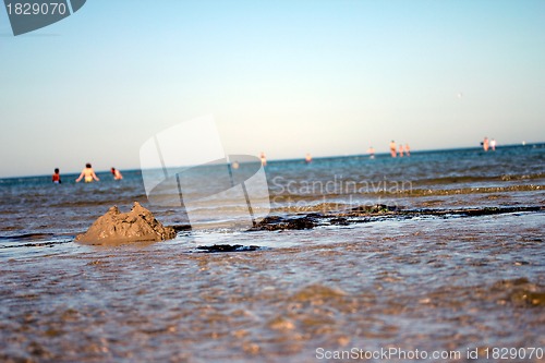 Image of broken sandcastle at the beach
