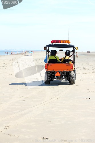 Image of lifeguards in a car at the beach