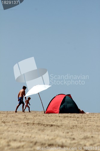 Image of lonely parasol and sun tent on the beach