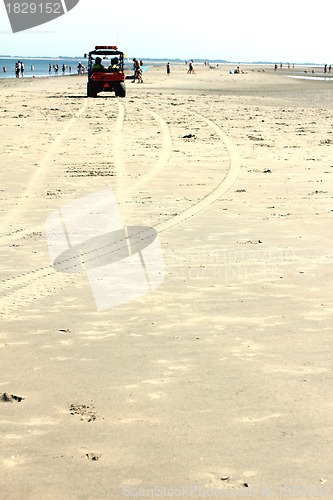 Image of lifeguards in a car at the beach