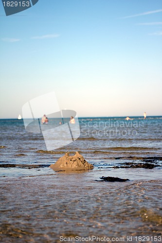 Image of broken sandcastle at the beach