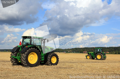 Image of Two John Deere Tractors on display