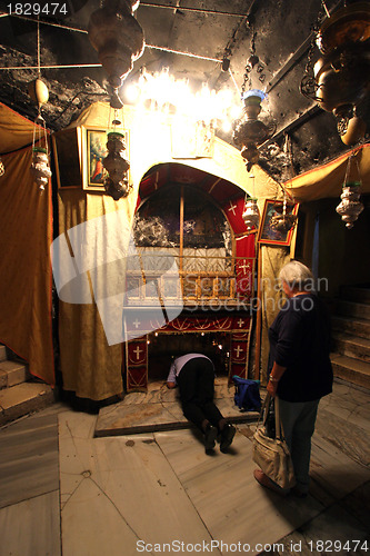 Image of Women pray at the silver star marks the traditional site of Jesus' birth in a grotto underneath Bethlehem's Church of the Nativity