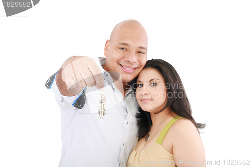 Image of Young smiling couple holding keys of their new house 