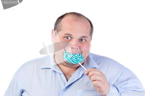 Image of Fat Man in a Blue Shirt, Eating a Lollipop